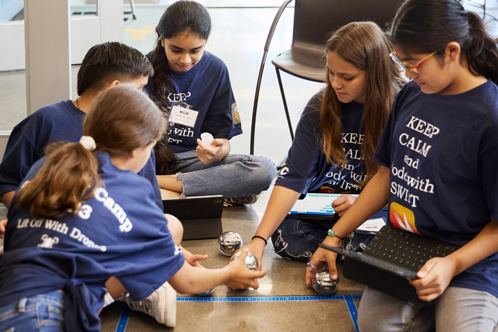 Sisters Soleil (far left) and Lluvia San Miguel (second from right) work with their fellow campers to guide Sphero robots through an obstacle course at Houston Community College’s technology summer camp.?